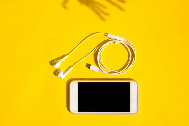 istock Smartphone and earphones on background 1402999053