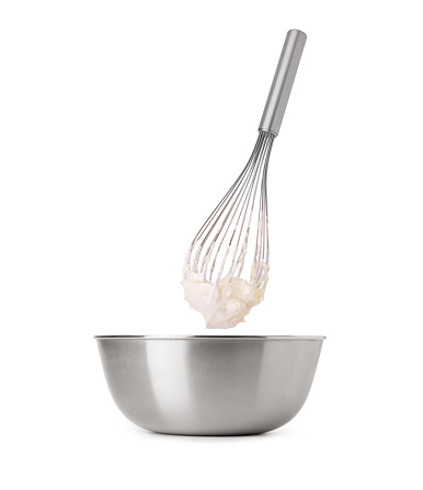 whipped cream and whisk in bowl