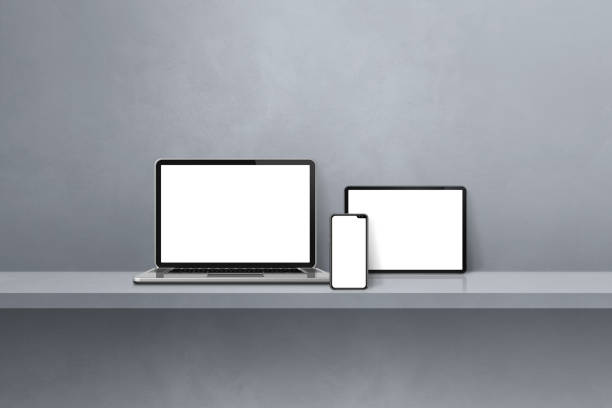 istock Laptop, mobile phone and digital tablet pc on grey wall shelf. Horizontal background 1403005585