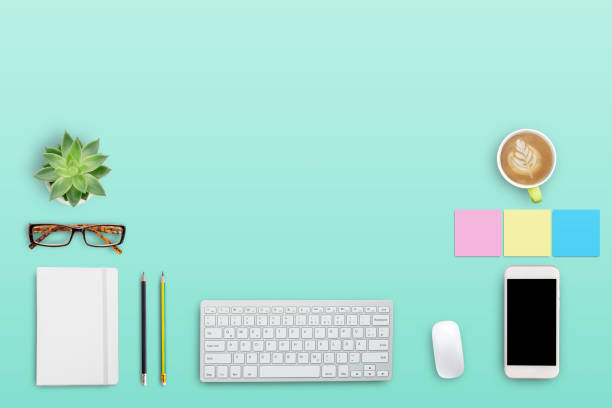 istock Top view modern workspace with coffee cup and laptop computer,notebook,glasses,smartphone on green background. 1403005586