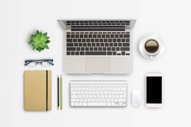 istock Top view modern workspace with coffee cup and laptop computer,notebook,glasses,smartphone on white table background. 1403005926