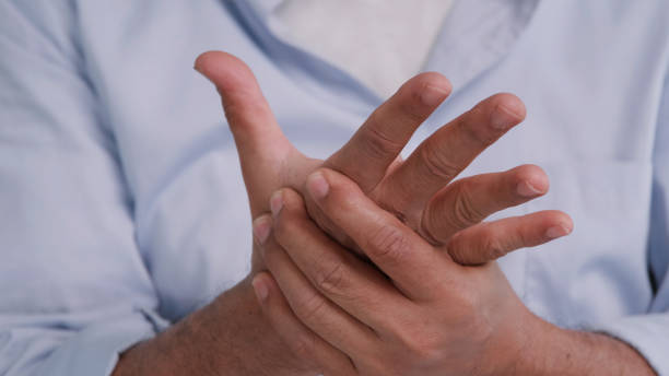 An Asian man has tingling and numbness in his hand which causes beriberi. An Asian man has tingling and numbness in his hand which causes beriberi. tingling hands stock pictures, royalty-free photos & images