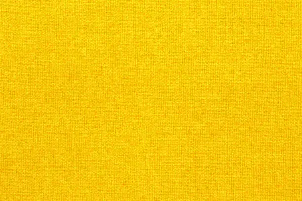 Photo of Yellow golden fabric cloth texture background, seamless pattern of natural textile.