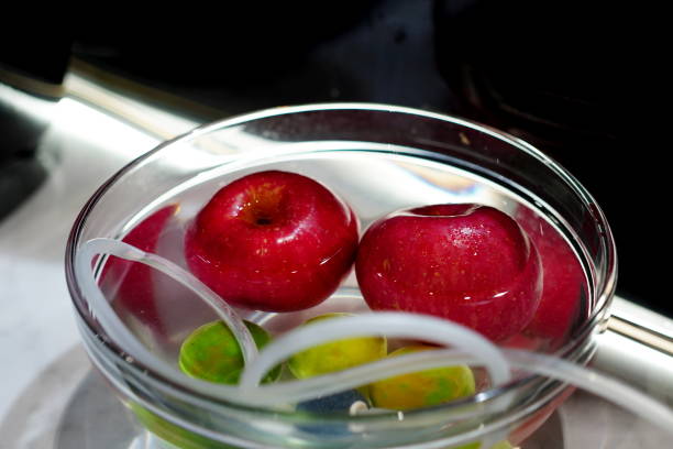 Cleaning apple in bowl of wate