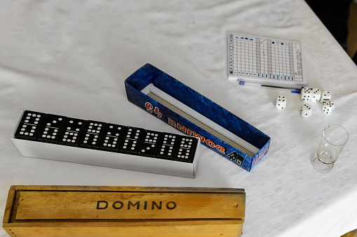 Close photo of dominoes and dice for yamb on the table.