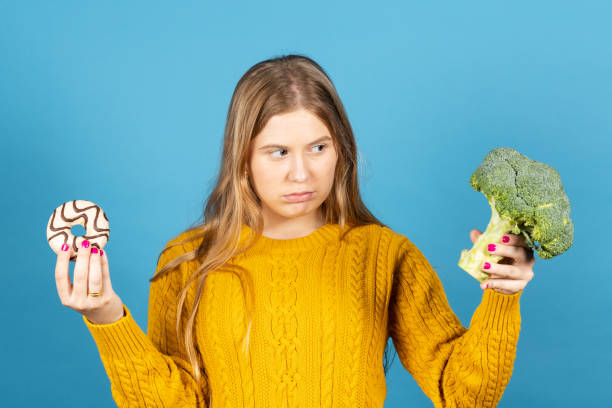 istock Young woman looking with frustration at broccoli 1403008661