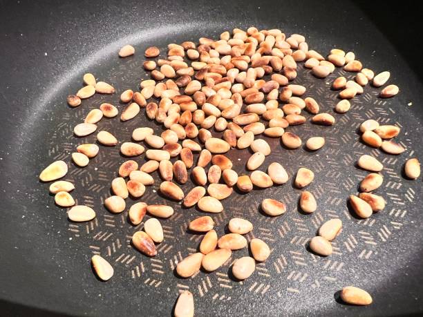 Lunch Dinner Pine nuts roasted in pan stock photo