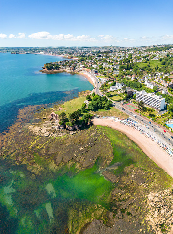 Seaweed covered rocks and beach and National Home Guard Memorial Headland in Torquay