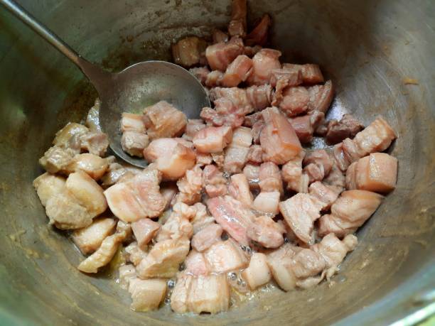 istock Frying Sliced Pork Belly in pan - food preparation. 1403015540