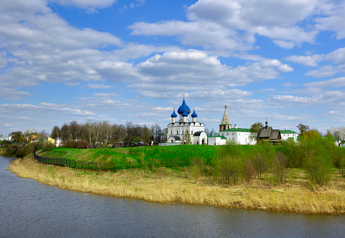 Suzdal, Vladimirovskaya oblast, Russia, 05.08.2022. Panorama of the Kremlin on the river bank. Assumption Cathedral and bell tower, Russian architecture of the XIII century