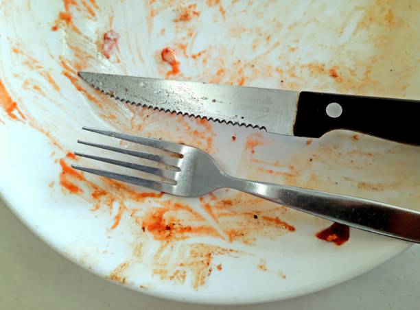 istock Eating Utensils on dirty plate - after meal. 1403016564