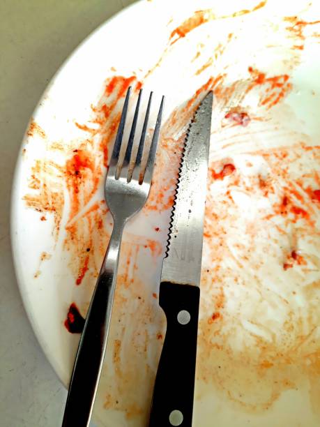 istock Eating Utensils on dirty plate - after meal. 1403016567