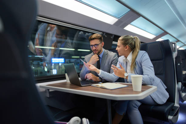 istock Business people traveling and working on the train using laptop 1403016889