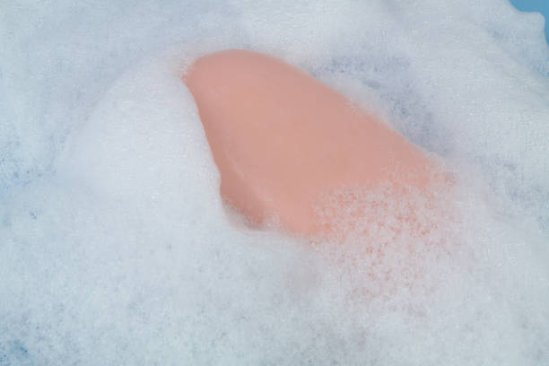 istock Foam bubbles and soap bar on blue background. 1403017017