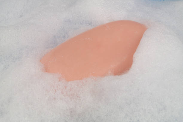 istock Foam bubbles and soap bar on blue background. 1403017030