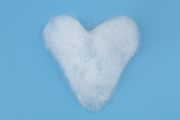 istock Heart from soap foam bubbles on blue background. 1403017338