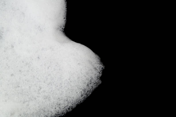 istock Soap or shampoo foam bubbles on black with copy space 1403017443