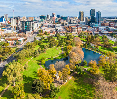Aerial wide view east side of Adelaide with beautiful Rymill Park adjacent in foreground: vibrant green colours, sunny, connection between city and environment, wellbeing, recreation, conservation, autumn colours, fresh air. 4x3 format