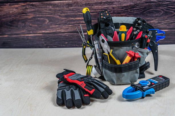 istock Electrician's bag with a professional electric tools, gloves, multimeter. 1403018652