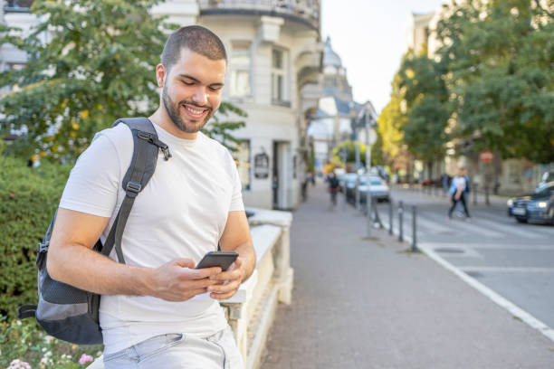istock Man holding smart phone and smiling 1403020350