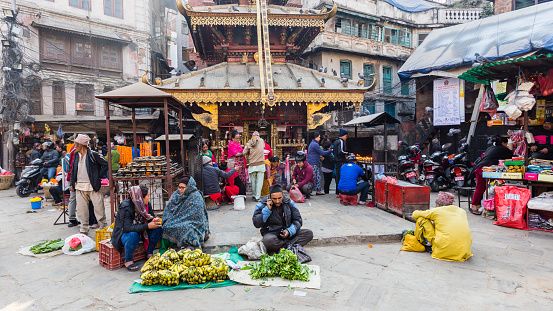 Kathmandu, Nepal - November 17, 2018: People sells fruits and vegetables at the street market in Kathmandu
