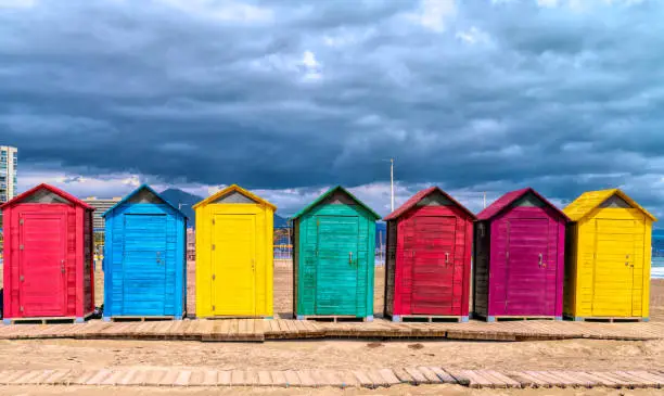 Beach huts in Spain bright colours with red green blue yellow purple