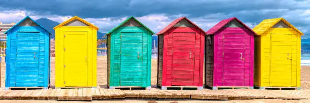 Spanish beach huts panoramic view with bright colours with red green blue yellow purple colours