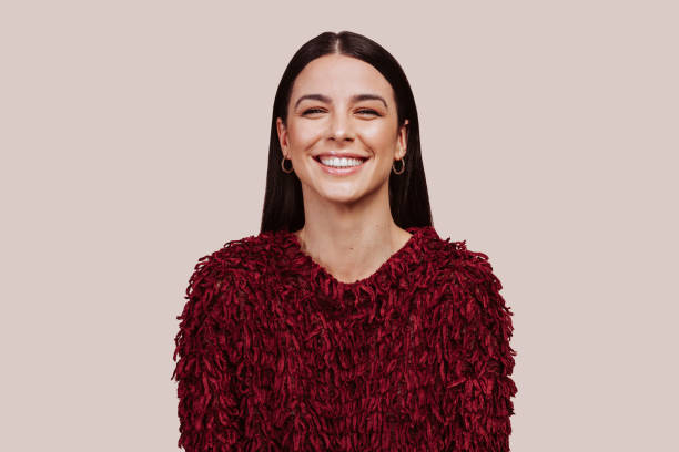 istock Young beautiful woman in red sweater smiling at studio 1403023566