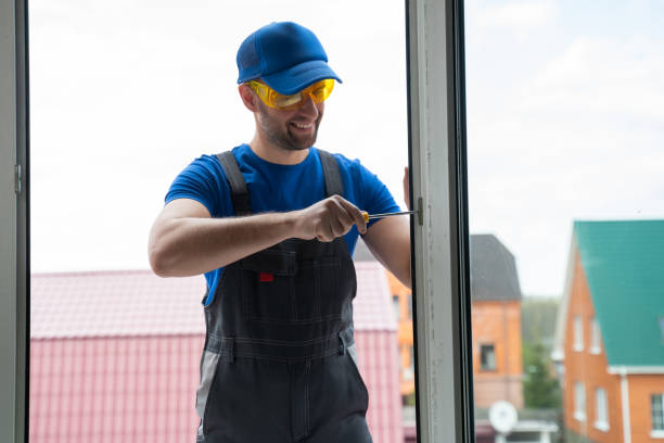 istock Worker fixes fastening for window with screwdriver outside 1403026019