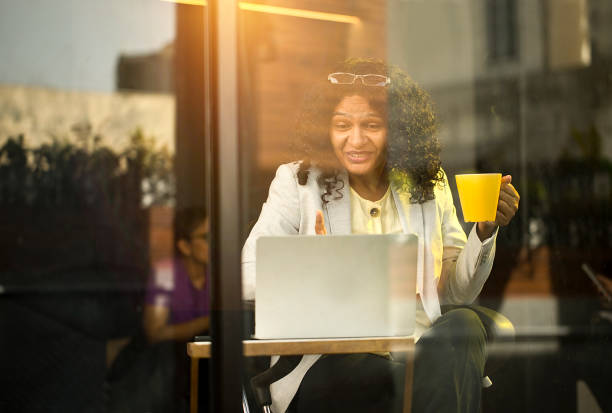 istock Businesswoman using laptop at cafe 1403026459
