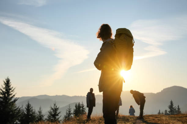 istock Tourists with backpacks in mountains on sunset 1403027028