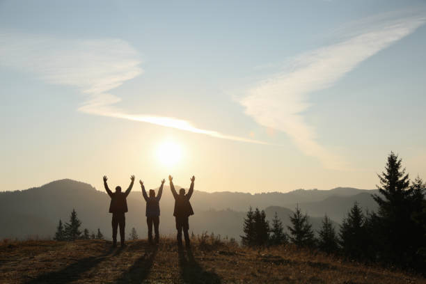 istock Group of people enjoying sunrise in mountains, back view. Space for text 1403027074