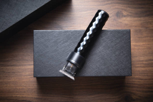 istock Black hair trimmer on wooden background. 1403027087