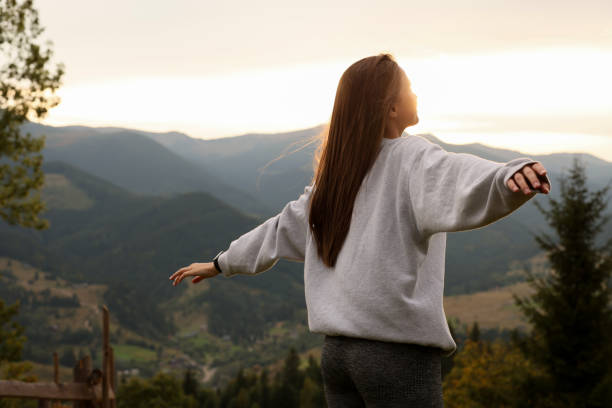 istock Beautiful young woman enjoying her time in mountains 1403027089