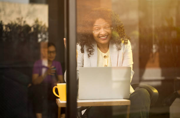 istock Happy businesswoman using laptop at cafe 1403027156