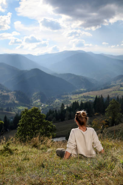 istock Woman enjoying beautiful mountain landscape, back view. Space for text 1403027184