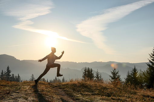 Young woman training outdoors at sunrise, space for text. Fitness lifestyle