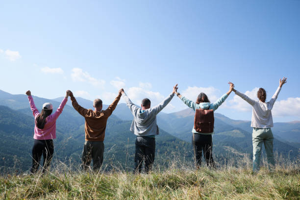istock Group of people spending time together in mountains, back view 1403027484