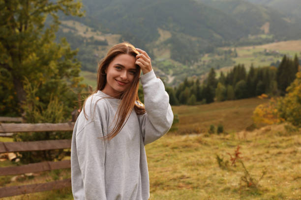 Beautiful young woman enjoying her time in mountains. Space for text
