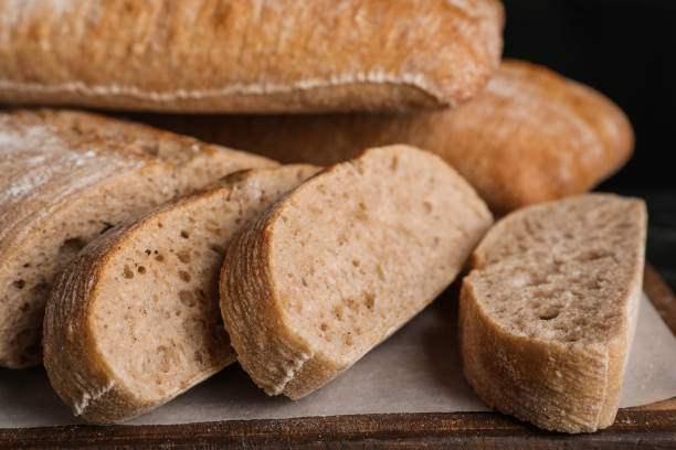 istock Wooden board with cut delicious ciabattas, closeup 1403027665