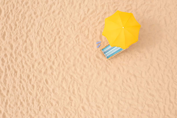 istock Yellow beach umbrella, sunbed and flip flops on sandy coast, aerial view. Space for text 1403027792