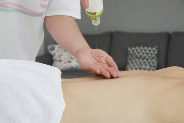 istock Mobile massage service. Young woman having soft shooting relax massage at home. 1403028205