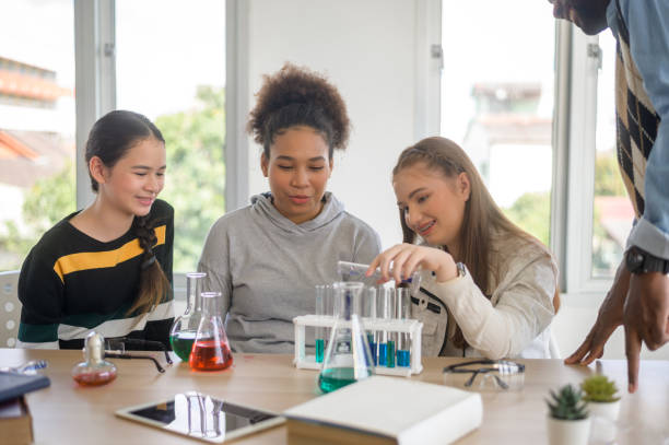 istock group of students studying and playing with teacher, education and learning concept. 1403029015