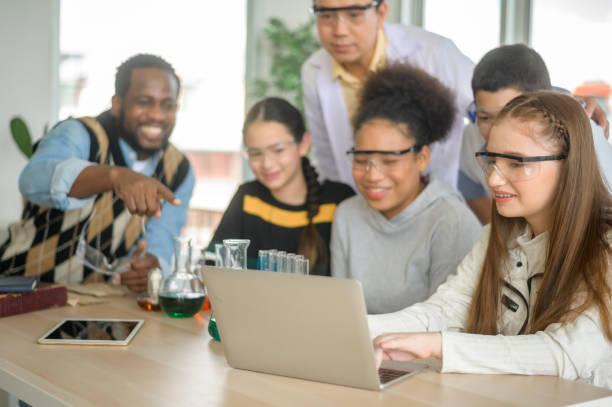 istock group of students studying and playing with teacher, education and learning concept. 1403029016