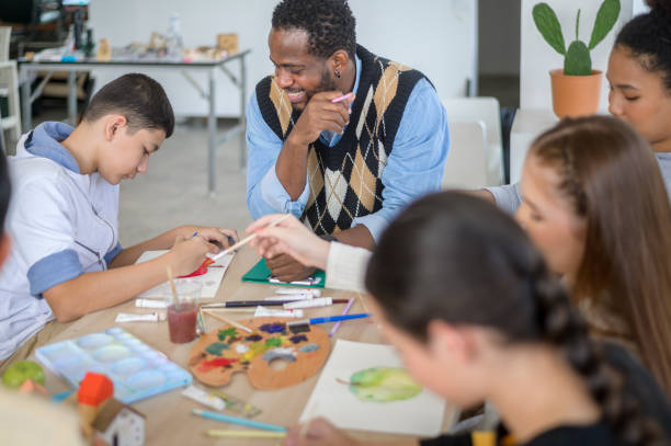 istock group of students studying and playing with teacher, education and learning concept. 1403029024