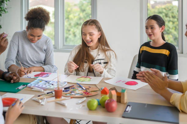 istock group of students studying and playing with teacher, education and learning concept. 1403029035