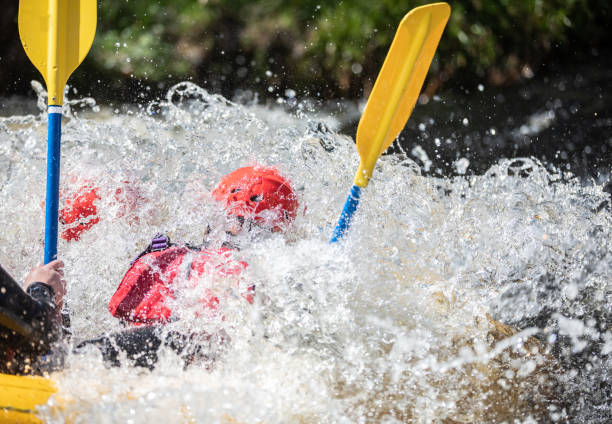 istock Kayak racing through the freshwater rapids dramatically submerging the Kayaker. 1403030021