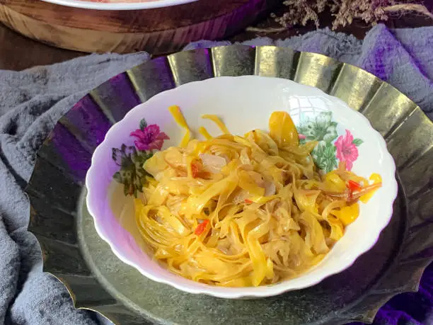 A bowl of dish made from ripe jackfruit rags.