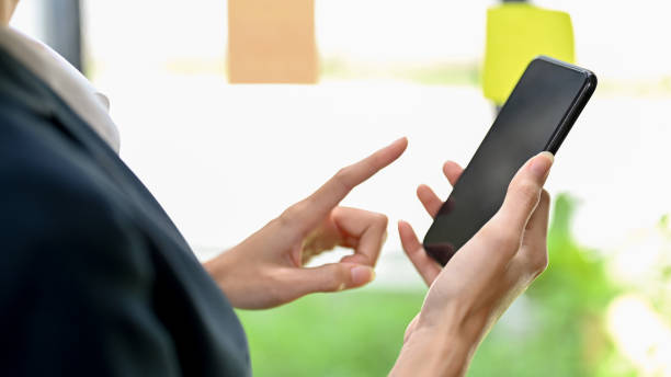 istock Close-up image, A female hand holding a smartphone, typing on cellphone screen 1403031042