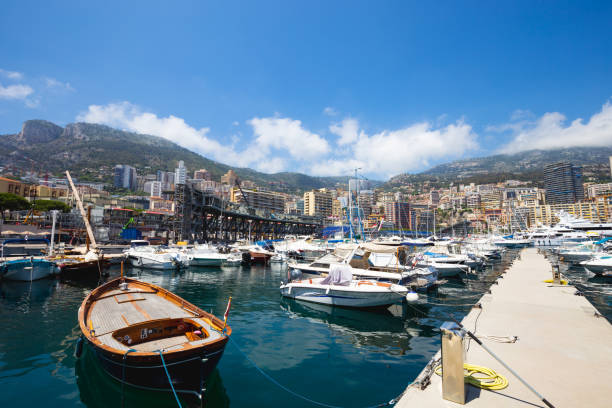Skyline of Monte Carlo with luxury yachts anchored in the harbor on a sunny day in Monaco-Ville, Monaco.